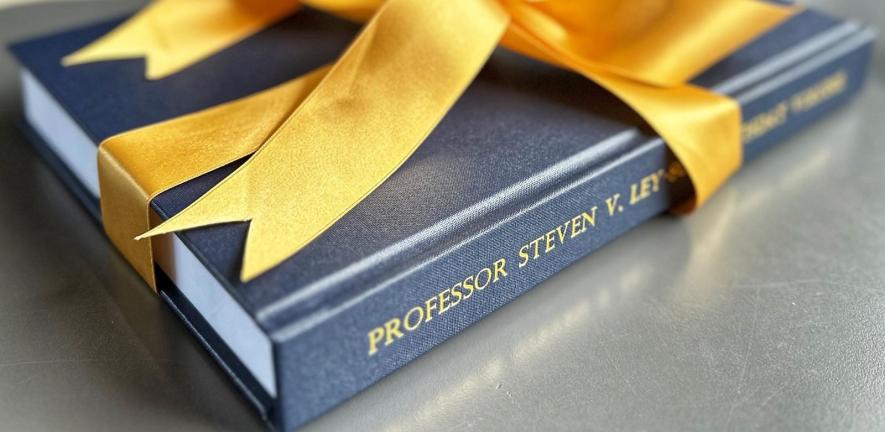 Book wrapped in yellow ribbon